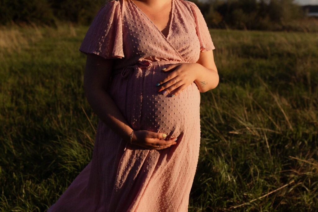 Close-up beeld van zwangere buik tijdens fotoshoot in de natuur